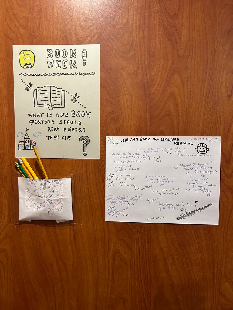 A poster and a pouch of pencils, taped up in the elevator
